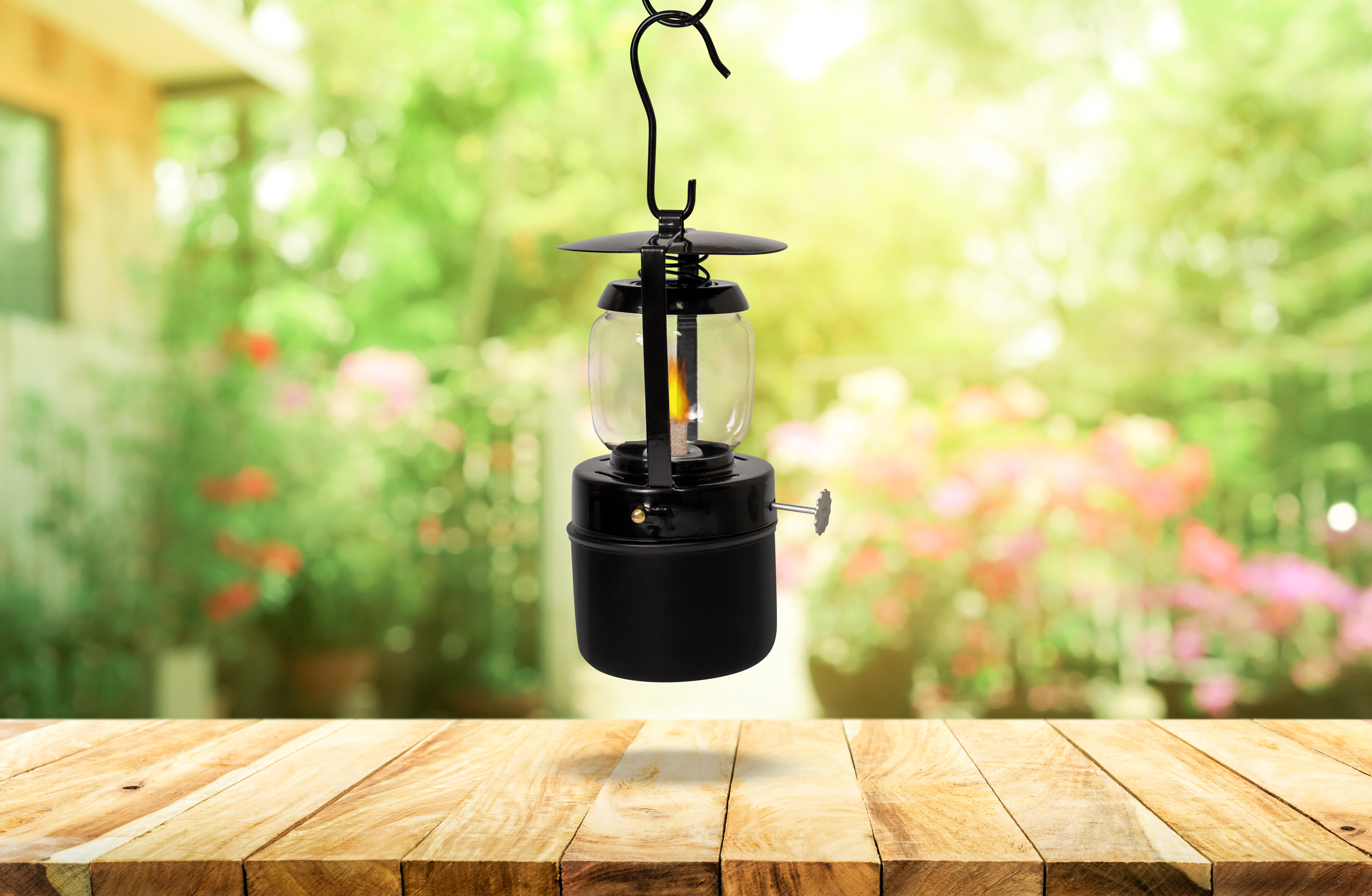 Empty wood table top on blur abstract green from garden and house background. For montage product display